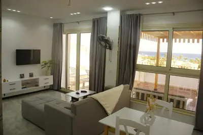 a living room with a couch and a table at Kite and Dive Home in Hurghada