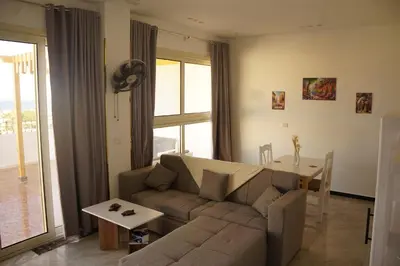 a living room with a couch and a table at Kite and Dive Home in Hurghada