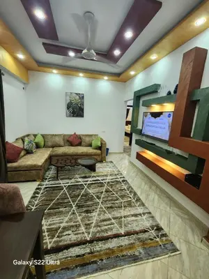 a living room with a couch and a tv at Abeer Suites 5 in Hurghada