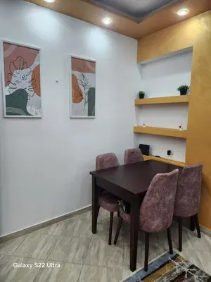 a dining room with a table and chairs at Abeer Suites 5 in Hurghada