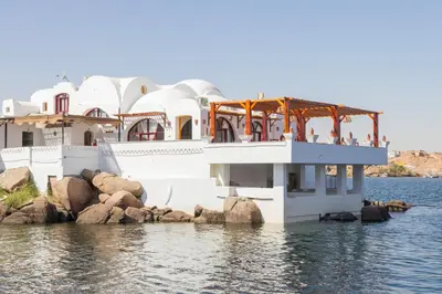 a boat in the water with people on it at Aro Kato Nubian Guest House in Aswan