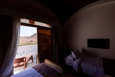 a bedroom with a bed and a window with a view at Aro Kato Nubian Guest House in Aswan