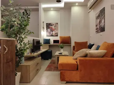 a living room with a couch and a tv at Capitan house beside Bellagio hotel 5 minutes from El gouna in Hurghada