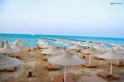 a group of umbrellas and chairs on a beach at Capitan house beside Bellagio hotel 5 minutes from El gouna in Hurghada