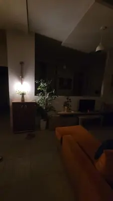 a dark living room with a couch and a light at Capitan house beside Bellagio hotel 5 minutes from El gouna in Hurghada
