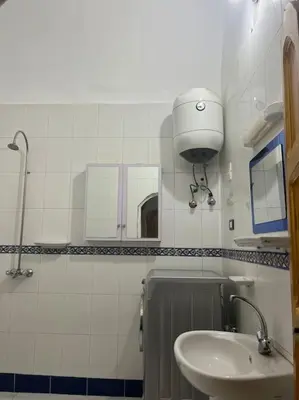 a bathroom with a sink and a mirror at Shamandy house same same but different in Jazīrat Aswān