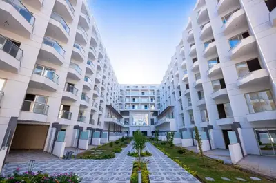 an apartment building with a pathway in front of it at Scandic Resort Hurghada Red Sea in Hurghada