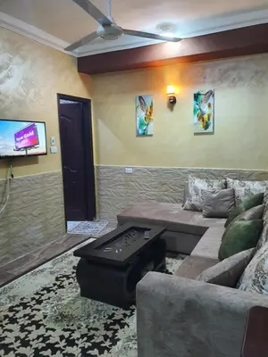 a living room with a couch and a flat screen tv at Abeer Suites 4 basement in Hurghada