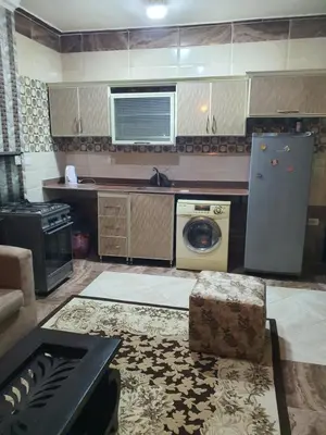 a kitchen with a washing machine and a washer and dryer at Abeer Suites 4 basement in Hurghada