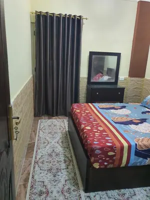 a bedroom with a bed and a television in it at Abeer Suites 4 basement in Hurghada