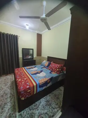 a bedroom with a bed and a ceiling fan at Abeer Suites 4 basement in Hurghada
