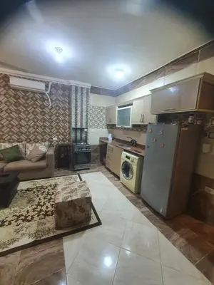 a kitchen and living room with a refrigerator and a couch at Abeer Suites 4 basement in Hurghada