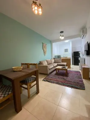 a living room with a table and a couch at Enjoy Makadi Heights Red Sea in Hurghada