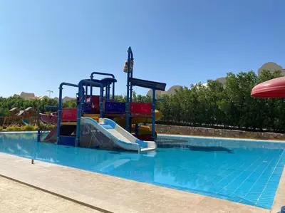 a water slide in a swimming pool at Enjoy Makadi Heights Red Sea in Hurghada