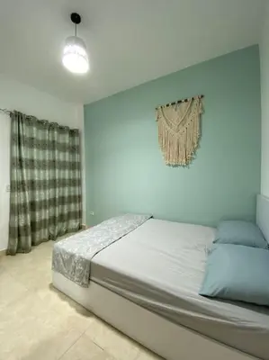 a bedroom with a large bed with a wall at Enjoy Makadi Heights Red Sea in Hurghada