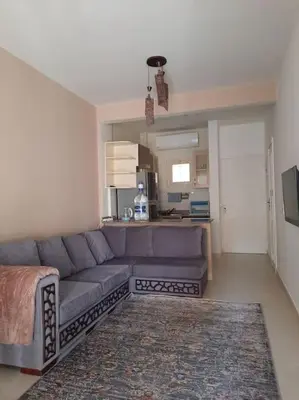 a living room with a couch and a kitchen at Relaxing time in Makadi Heights in Hurghada