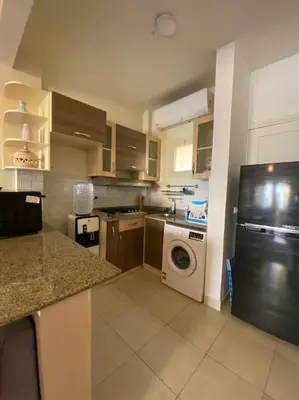 a kitchen with a refrigerator and a washing machine at Relaxing time in Makadi Heights in Hurghada