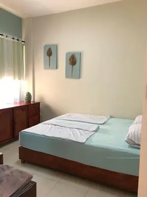 a bedroom with a bed and a dresser in it at Relaxing time in Makadi Heights in Hurghada