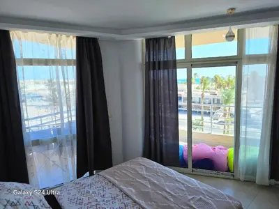 a bedroom with a bed and a large window at Sea view Prinessa Resort in Hurghada
