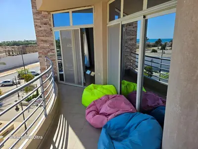 a balcony with three sleeping bags on the floor at Sea view Prinessa Resort in Hurghada
