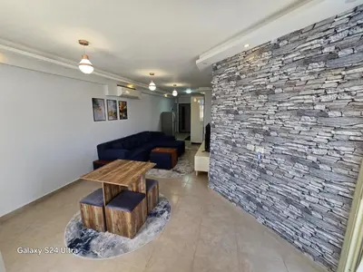 a living room with a stone wall at Sea view Princessa Resort in Hurghada
