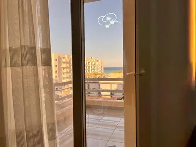 a sliding glass door with a view of a city at Downtown Keys in Hurghada