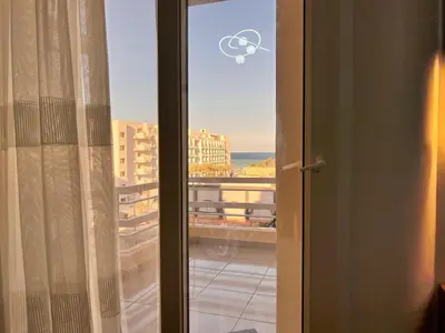 a sliding glass door with a view of a city at Downtown Keys in Hurghada