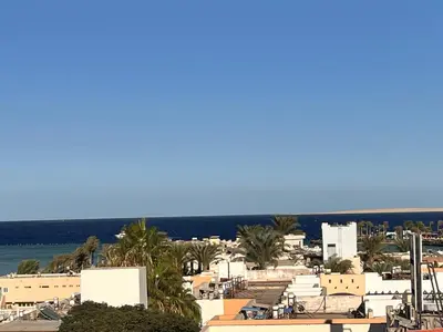 a view of a beach with buildings and the ocean at Downtown Keys in Hurghada