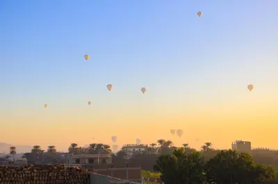 a group of hot air balloons flying in the sky at Moka Gust House in Luxor