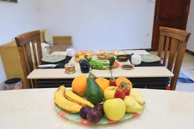 a plate of fruits and vegetables on a table at Moka Gust House in Luxor