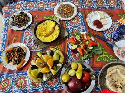 a table with plates of food on a table at Ali Toot in Luxor