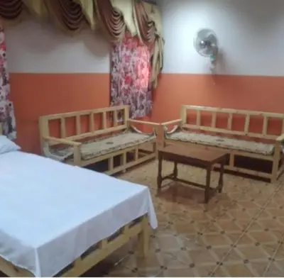 a room with two benches and a table in it at Ali Toot in Luxor