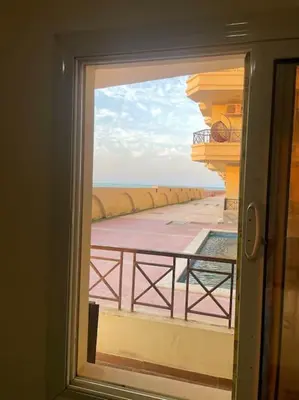 a view of a balcony from a window at Beach Side 1 Bedroom Apartment in Hurghada