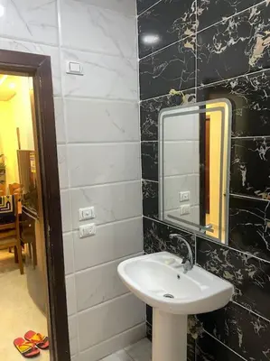 a bathroom with a sink and a mirror at Beach Side 1 Bedroom Apartment in Hurghada