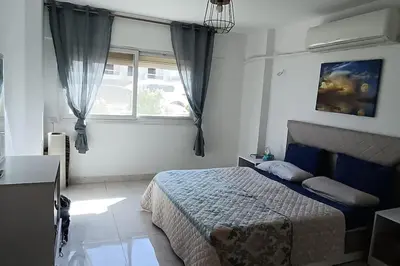 a bedroom with a bed and a window at Cozy 1 bedroom Seaview escape in Hurghada