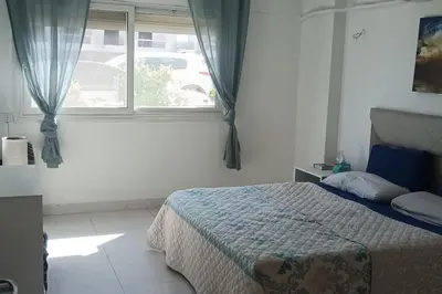 a bedroom with a bed in front of a window at Cozy 1 bedroom Seaview escape in Hurghada