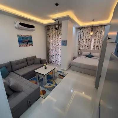 a living room with a couch and a bed at Hurghada Airport Aparthotel - SAHLHOMES in Hurghada
