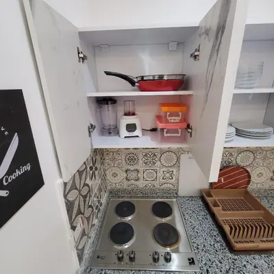 a miniature kitchen with a sink in the middle at Hurghada Airport Aparthotel - SAHLHOMES in Hurghada