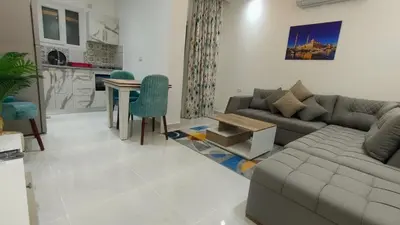 a living room with a couch and a table at Hurghada Airport Aparthotel - SAHLHOMES in Hurghada