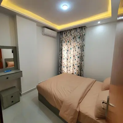 a bedroom with a bed and a mirror and a television at Hurghada Airport Aparthotel - SAHLHOMES in Hurghada