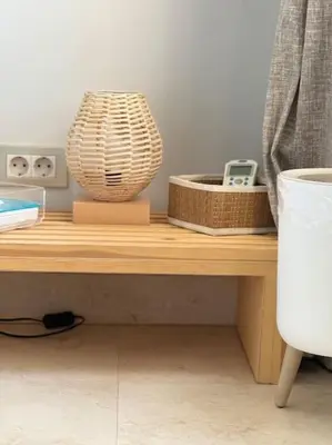 a wooden table with a vase and baskets on it at The Charming Beachfront Retreat in Fanadir in Hurghada