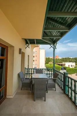 a patio with a table and chairs on a balcony at Ocean View: Spacious 2-Bed Apt in Hurghada