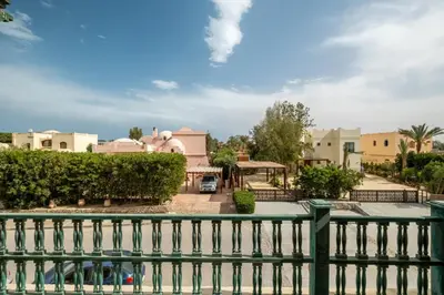 a view of a house from a fence at Ocean View: Spacious 2-Bed Apt in Hurghada