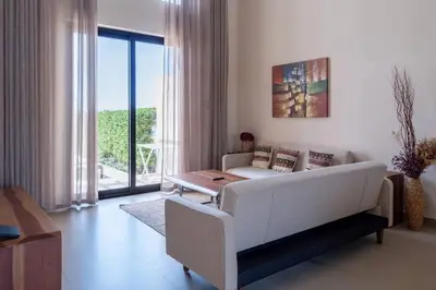 a living room with a white couch and a table at Luxury 4BR + Nanny Villa • Ancient Sands in Hurghada