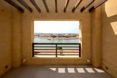 a room with a window with a view of the water at Luxury 4BR + Nanny Villa • Ancient Sands in Hurghada