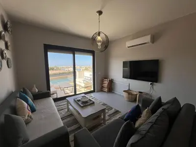 a living room with a couch and a table at Chic Cyan 3BR Apt. • Prime Location in Hurghada