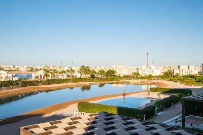 a view of a pool with a city in the background at Chic Cyan 3BR Apt. • Prime Location in Hurghada