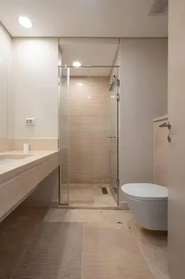 a bathroom with a shower and a toilet and a sink at Newly Furnished & Bright 2BR Apt: Mangroovy in Hurghada