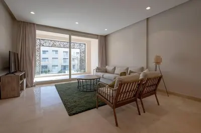 a living room with a couch and a table at Newly Furnished & Bright 2BR Apt: Mangroovy in Hurghada