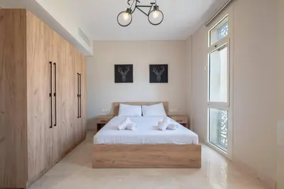 a bedroom with a bed and a large window at Newly Furnished & Bright 2BR Apt: Mangroovy in Hurghada